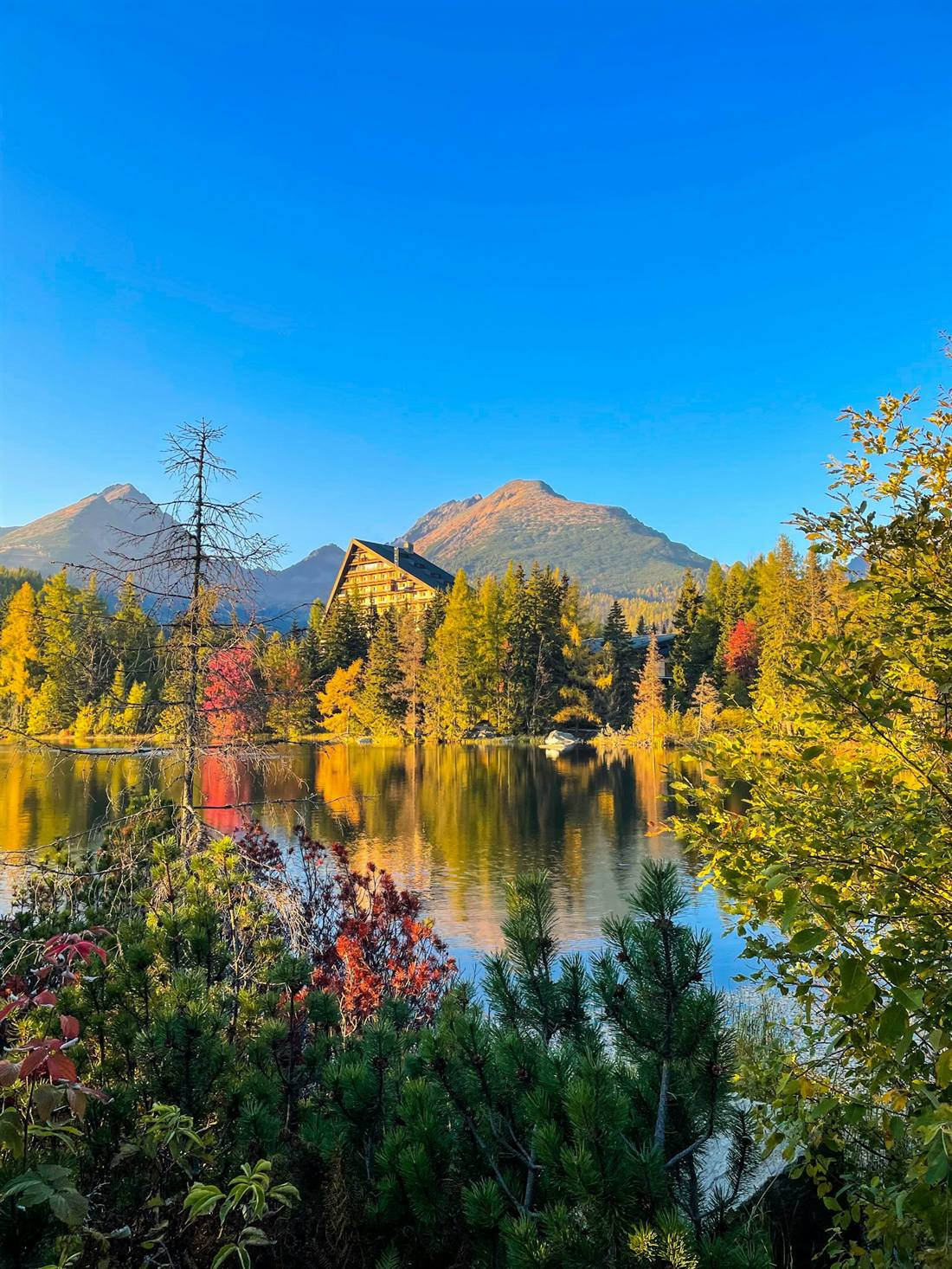 Štrbské pleso na jeseň s tatranskými štítmi v pozadí